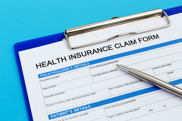 Health insurance claim form with pen
