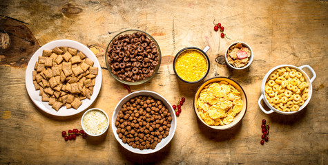 Cereal in cups. On wooden background.