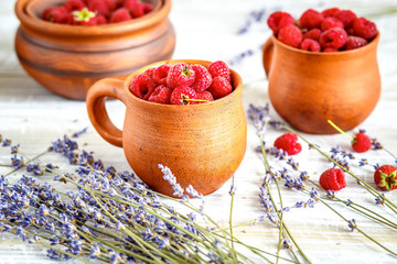 pottery with strawberries and lavender on wooden table