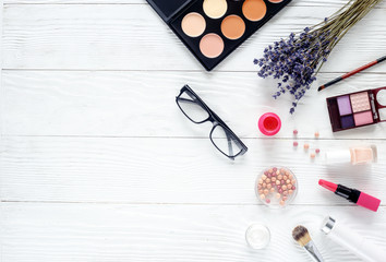 make up set on wooden table with lavender top view