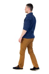 Back view of going handsome man. walking young guy . Isolated over white background. a man in a blue shirt with the sleeves rolled out to the right