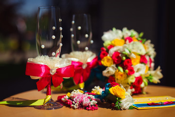 Elegant champagne flutes decorated with laces and ribbons stand