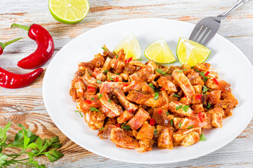 Braised Pig Ears with spices, chili pepper, pieces of lime