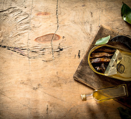 Smoked sprats in oil with the Bay leaf.