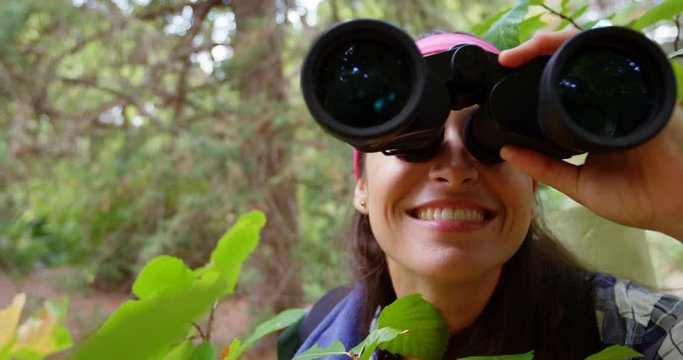 Close up of hiker using binoculars