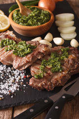 grilled beef steak with chimichurri sauce on slate board. Vertical
