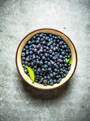 Fresh blueberries in a Cup. On stone table.
