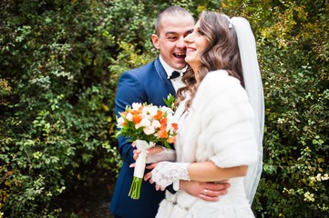 Wedding couple against a background of green bushes