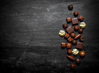 Chocolates. On wooden background.