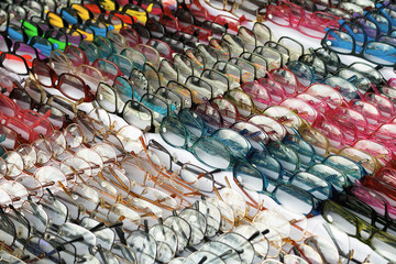 Colorful Sunglasses on sale at the city market, soft focus.