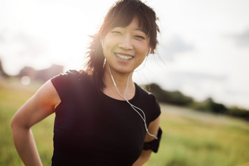 Happy female running standing outdoors and smiling