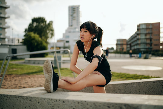 Young woman stretching in sports gear