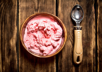 Sweet raspberry ice cream with a spoon.