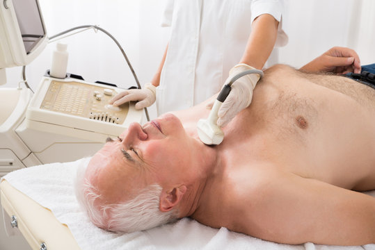 Man Getting Ultrasound Scan On Neck By Doctor