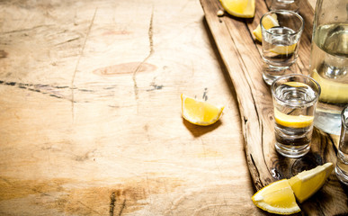 Vodka in shot glasses with lemon.