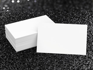 stack of name cards on black glitter background