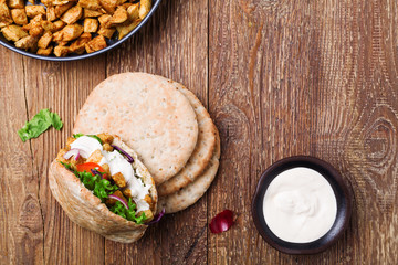 Pita salad with roasted chicken and vegetables, served with a de