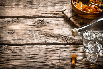 Russian style. Vodka with pickled mushrooms.