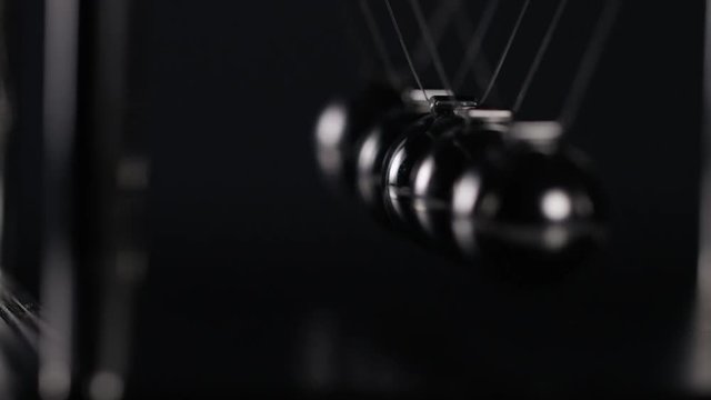 4K Abstract angle of Newton's cradle spheres, in slow motion