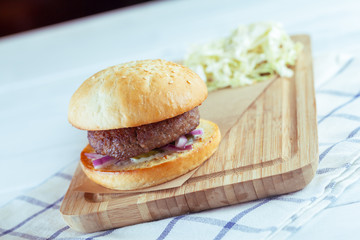 home made burgers on wooden background
