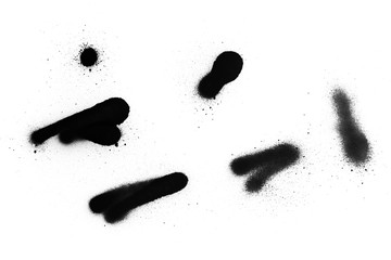 Black color spray paint on a white background paper