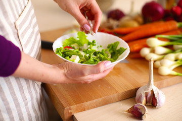 Young Woman Cooking in the kitchen. Healthy Food