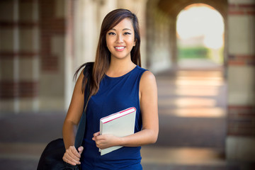 Cute portrait of a single student carrying book and school bag young american 