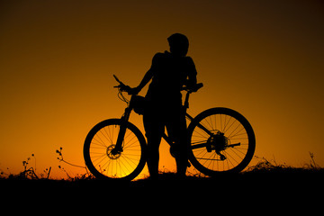 Plakat sunset and silhouette backlight bikers