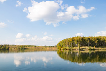 Fototapeta na wymiar Calm clear lake in the woods. Autumn, september landscape