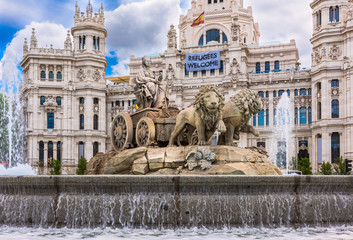 Fototapeta na wymiar Cybele's fountain on Cybele's Square (Plaza de la Cibeles) and Central Post Office (Palacio de Comunicaciones) in Madrid, Spain