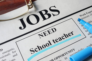 Newspaper with ads for vacancy School teacher. Employment concept.