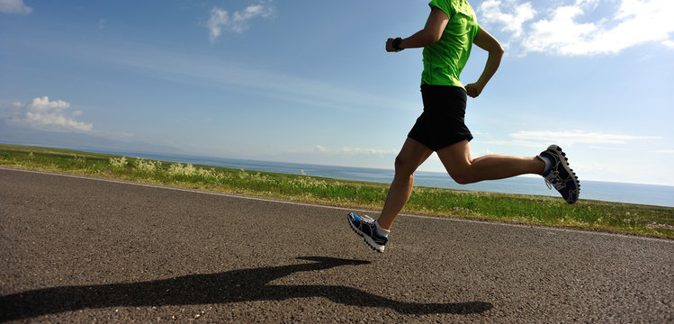 healthy lifestyle woman runner running on road