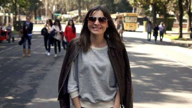 Happy, pretty woman walking on street in city, super slow motion 240fps
