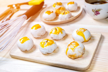 Chinese pastries with a cup of tea and baking utensils on wood table
