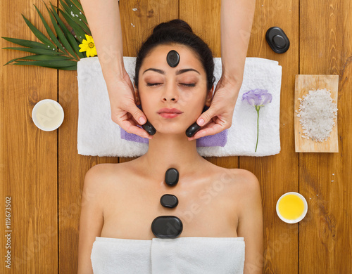 Beautician Make Stone Massage Spa For Woman At Wellness Center Photo