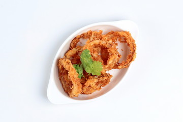 Dish of fried onion rings on white background.