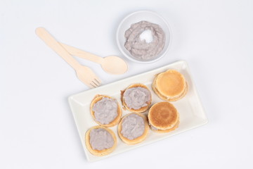 Fototapeta na wymiar Mini pancake topped stirred taro on white background.