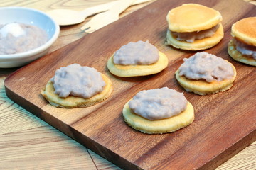 Mini pancake topped stirred taro on wood. Selective focus