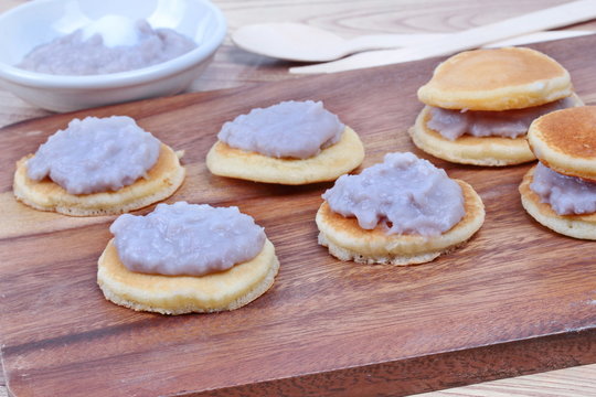 Mini pancake topped stirred taro on wood. Selective focus