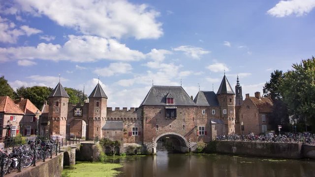 Bikes and pedestrians passing an old medieval city gate, the Netherlands, 4K time lapse