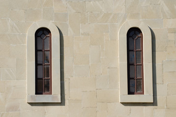 Two narrow arched windows in the old style