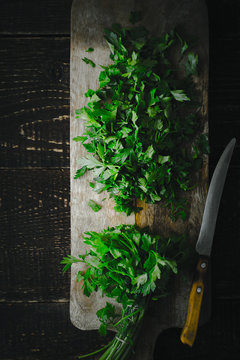 Cutting  parsley on the wooden board top view