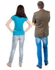 Back view of young couple man and woman hug and look into the distance. beautiful friendly girl and guy together. Rear view. Isolated over white background. young woman holds the hand of her husband