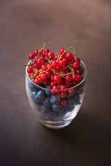 A glass full of tasty blueberries and red currants