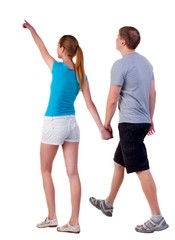 Back view of walking young couple (man and woman) pointing. going tourists in shorts considering attractions. Rear view people collection. backside view of person. Isolated over white background