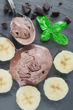 Chocolate ice cream with chocolate pieces and bananas. Top view image.