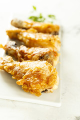 Battered chicken on white plate