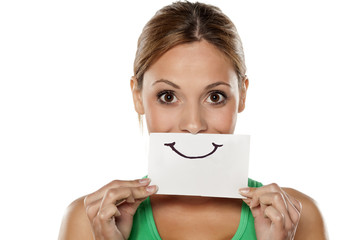 happy young woman with emotions drawn on a piece of paper