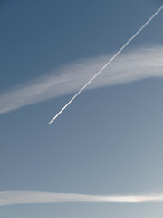 Fototapeta na wymiar Airplane leaves a condensation trail
