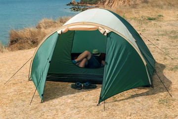 Camping young girl setting a tent